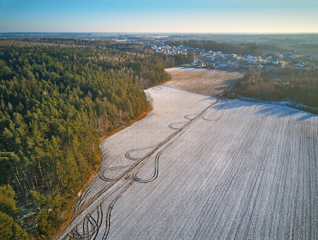 Winter landbouwgebied onder de sneeuw. Luchtscène. December Landelijk landschap. Platteland bovenaanzicht. Minsk regio, Wit-Rusland