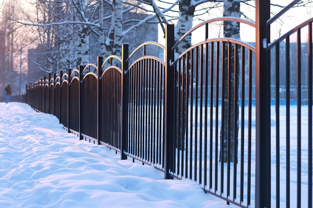 Winter landscape iron fence at sunset