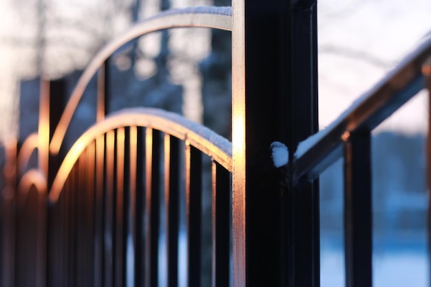 Winter landscape iron fence at sunset