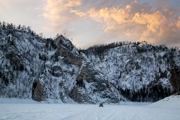 Winter landscape majestic mountains and rocks snow and ice sunset sky