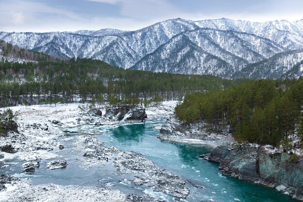 Winter landscape Mountains and river under snow