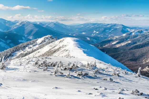 Winter landscape in mountains with snow and blue hills