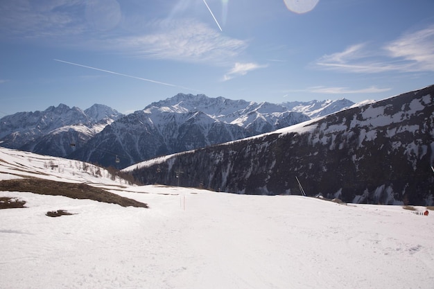 Winter landscape Panorama of the ski resort with ski slopes and ski lifts with blue sky on background Alps Austria Karnten