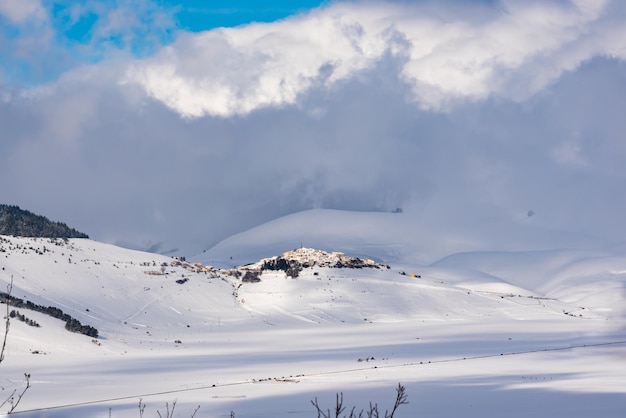 Winter landscape valley and hills covered with snow on bright sunny day