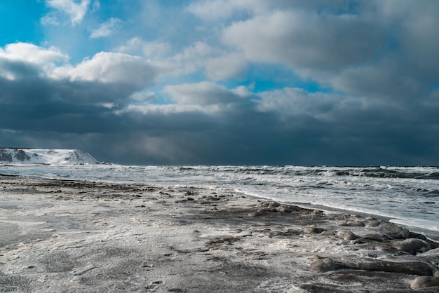 Winter landscape with frozen sea and icy beach storm and snow weather dramatic seascape