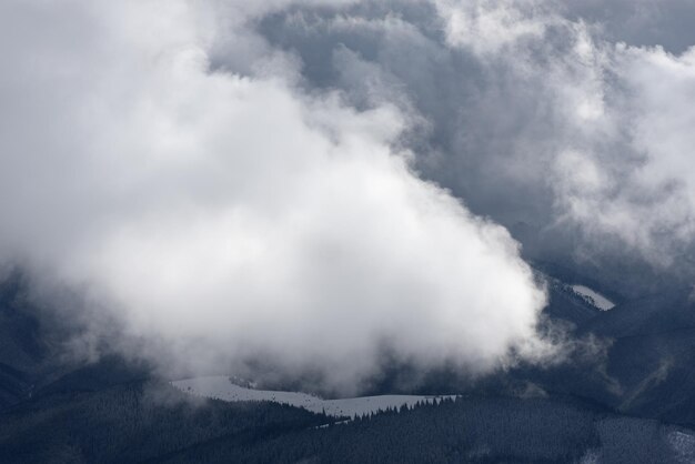 Winter landscape with low clouds in the mountains