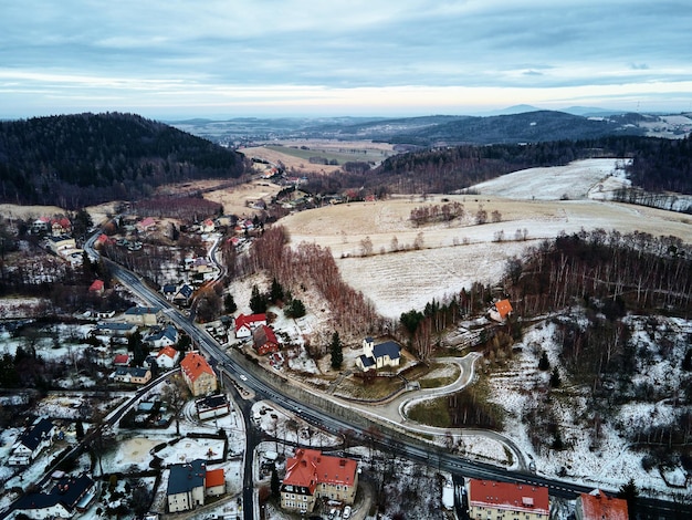 Winter landscape with mvillage near mountains