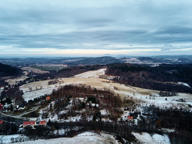 Winter landscape with mvillage near mountains