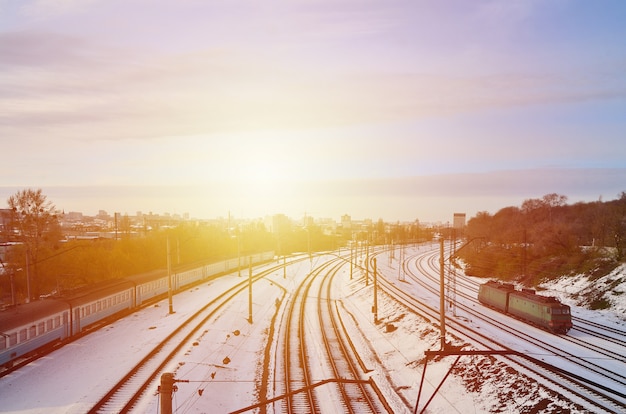 Winter landscape with a railway train against a cloudy sky background