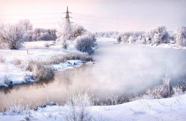 강과 눈 덮인 나무가 있는 겨울 풍경