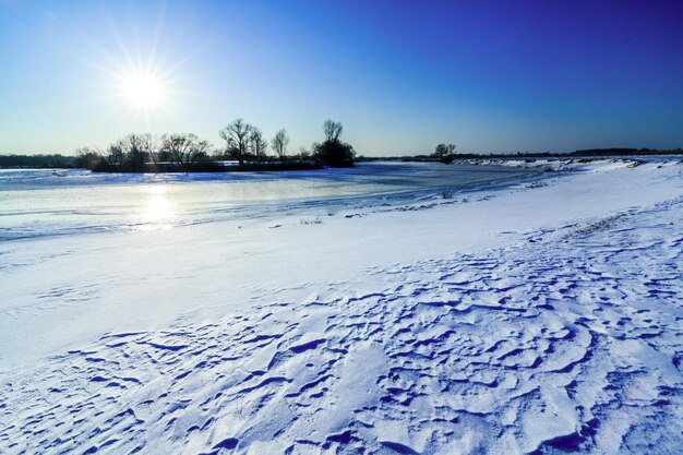 Winter landscape with the river and snow in frosty day