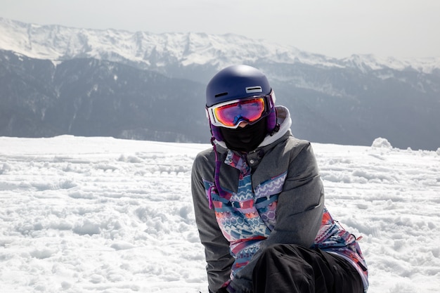 Winter landscape with snowboarder and mountains