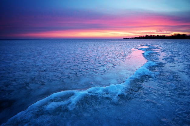 Winter landscape with sunset fiery sky. Composition of nature.