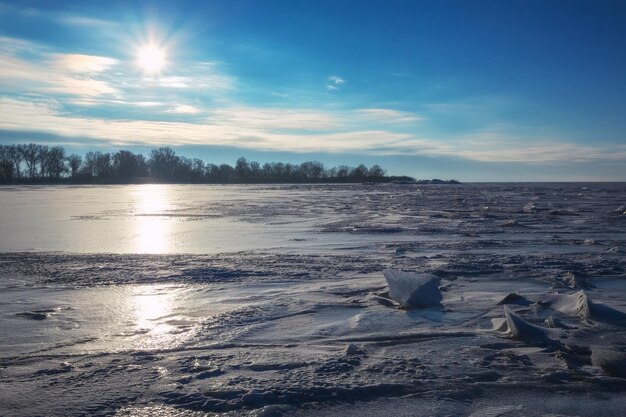 Winter landscape with sunset sky and frozen sea. Daybreak