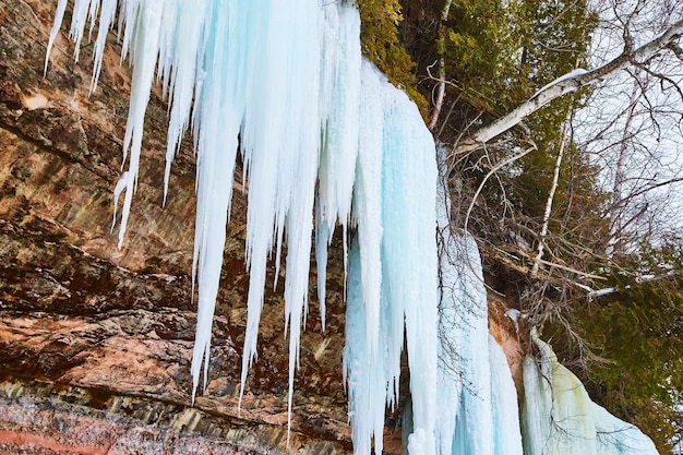 Winter large blue icicles on cliffs