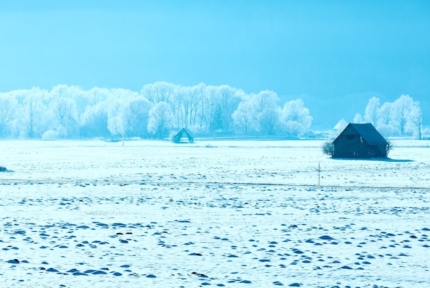 Winter mountain country landscape with wooden shed(Austria).