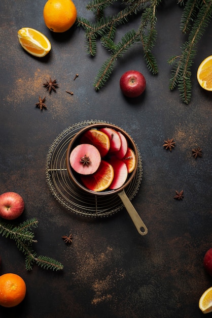 Winter mulled wine with orange, apple, cinnamon and anise star, winter concept