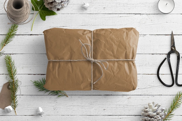 Photo winter nature scene with brown parcel and gift items