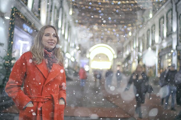 winter night in the city lights / adult girl in a coat walk in the city, fashionable stylish image of a beautiful model