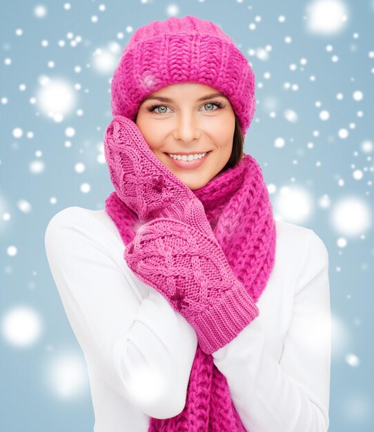 winter, people, happiness concept - woman in hat, muffler and mittens