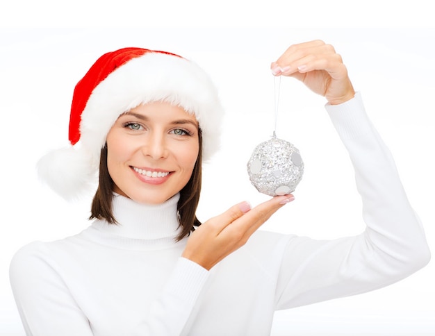 winter, people, happiness concept - woman in santa helper hat with christmas tree decoration