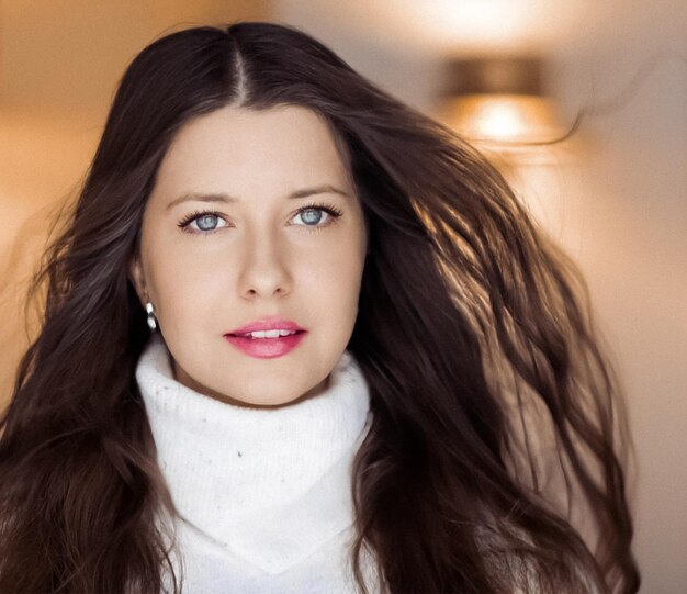 Winter portrait and christmas holiday look beautiful woman in white sweater with long brown hair and...