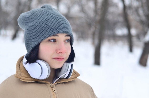 Winter portrait of young girl with headphones