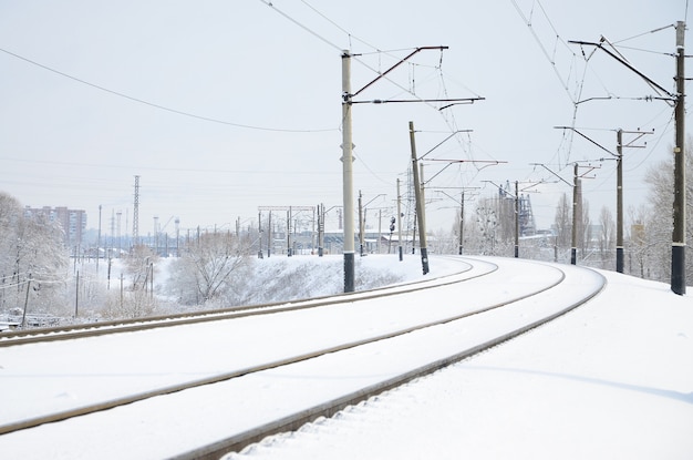 Winter railway landscape, Railway tracks in the snow-covered industrial country