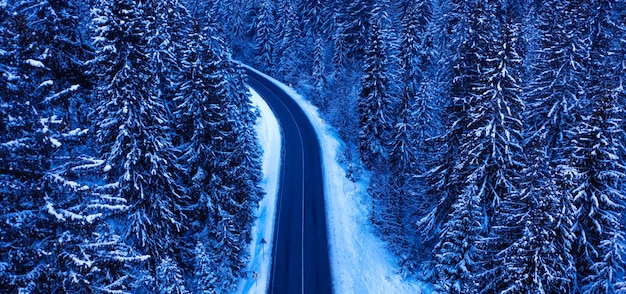 Winter road in the mountains drone view