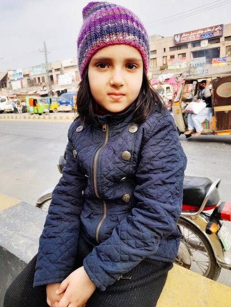 Winter season  cute girl  pakistani shining eyes beautiful  inocent  lovely  smiling face  sitting
