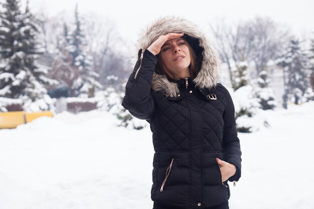 Winter season and young attractive woman in the forest