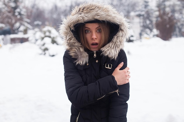 Winter season and young attractive woman in the forest