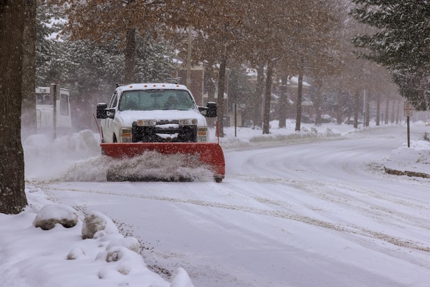 Photo winter service truck with snowplow removing snow clearing road maintenance in after heavy snowfall