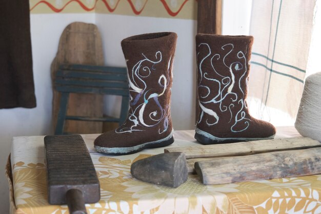 Winter shoes valenki on a wooden table