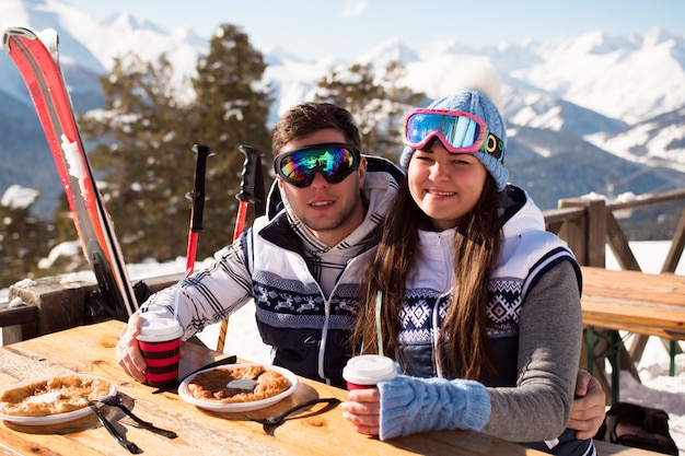 Winter, ski - skiërs genieten van lunch in de winterbergen.