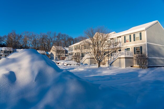 Winter snow covered houses and buildings against clear blue sky in christmas holiday