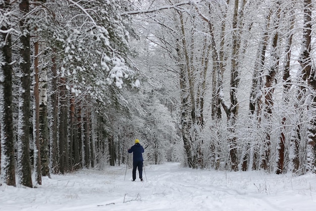 Winter snow sport man run in tree park