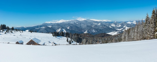 Winter snowy mountains and lone farmstead