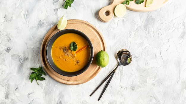 Winter spicy carrot cream soup on light background Vegetarian vegetables creamsoup Long banner format top view