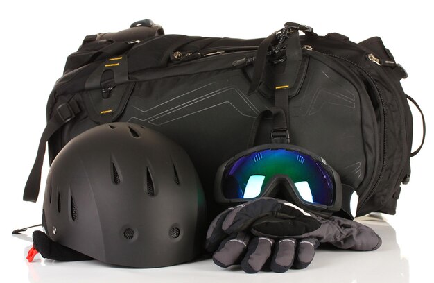 Winter sport glasses helmet and gloves backpack isolated on white