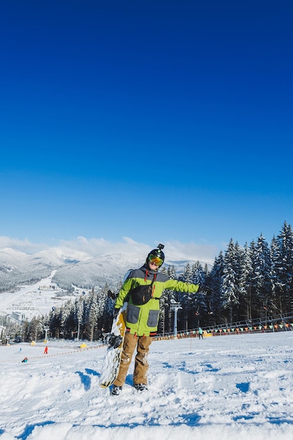 Winter sport A snowboarder walks down a snowy slope in winter on the snow Snowboarding winter freeride