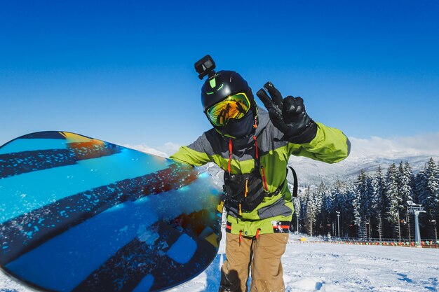 Winter sport a snowboarder walks down a snowy slope in winter on the snow snowboarding winter freeride