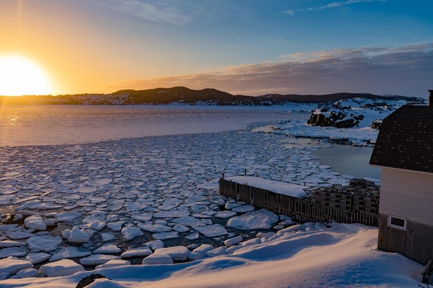 Winter sun sets over frozen ocean bay NL Canada