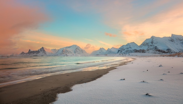 Winter sunset over the sea coast and mountains colorful northern sunrise and sunlight in pink clouds Lofoten Islands Norway Europe