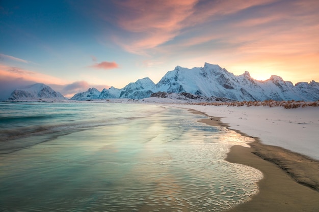 Tramonto invernale sul mare e sulle montagne alba settentrionale colorata e luce solare in nuvole rosa isole lofoten in norvegia europa