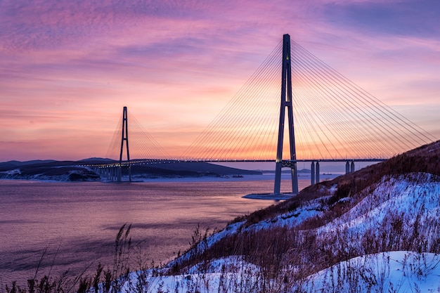 Winter sunset view of long cable-stayed bridge in Vladivostok