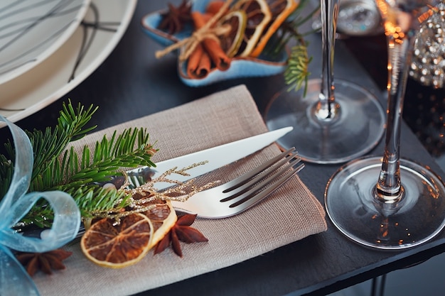 Winter table setting with Christmas decoration. Home interior.