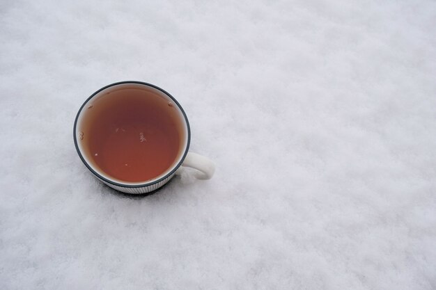 Winter tea. A cup of tea in the snow