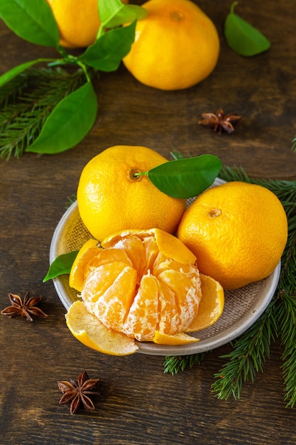Winter time fruits Fresh juicy clementine mandarins with leaves on rustic wooden table
