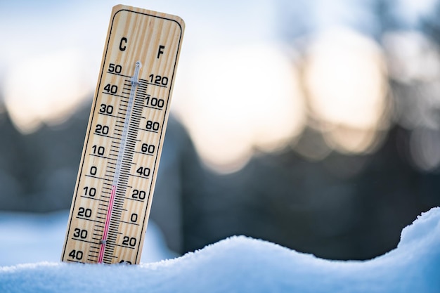 Winter time thermometer on snow shows low temperatures